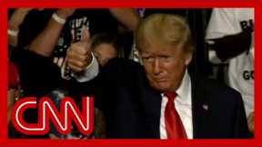 Trump speaks at rally while music resembling a QAnon song plays